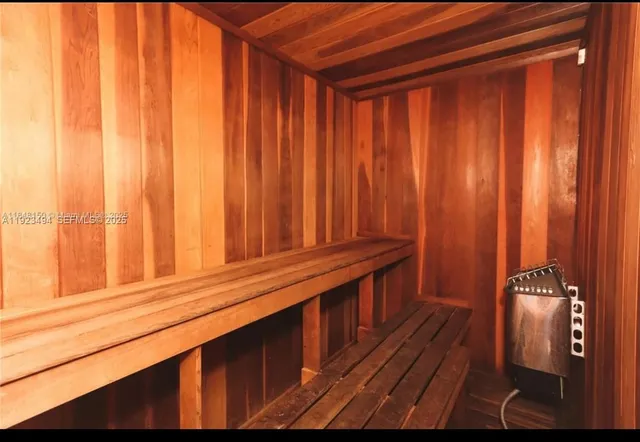 a front view of a house with a tree