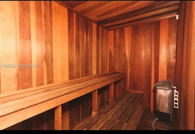 a front view of a house with a tree