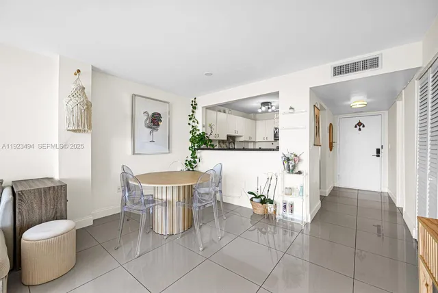 a living room with furniture and a dining table
