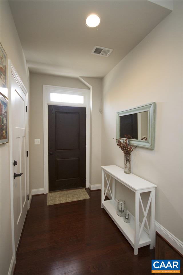 2142 Avinity Loop Charlottesville, VA 22902 - Photo 6 of 31 a living room with a flat screen tv on wall and a potted plant