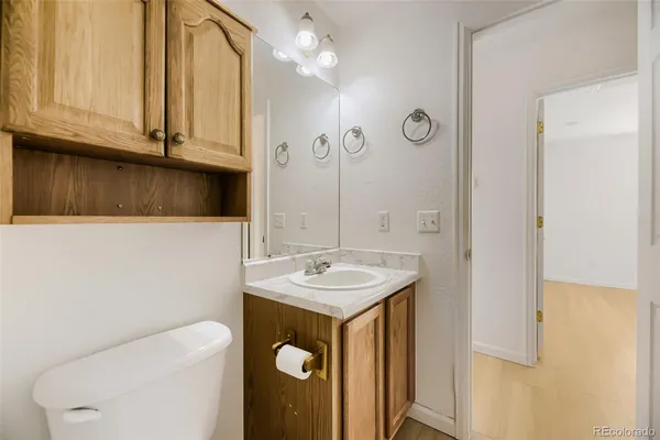 a view of a kitchen with refrigerator and cabinets