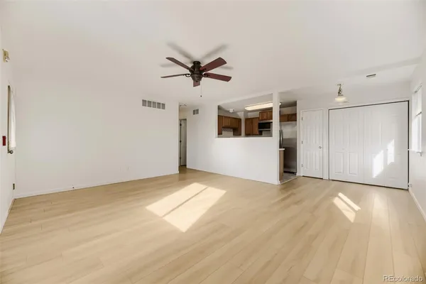 an empty room with windows and closet