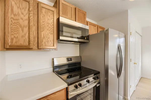 a kitchen with wooden cabinets and a stove top oven