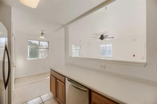 a kitchen with stainless steel appliances granite countertop a sink and a white cabinets