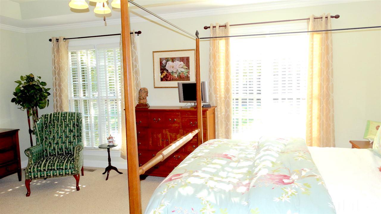 10335 Evergreen Spring Place Raleigh, NC 27614 - Photo 10 of 25 FIRST FLOOR MASTER EN SUITE! Large enough to hold sitting room furniture, tray ceiling, light sconces on either side of the bed, with enough Natural Light from the (2) windows.