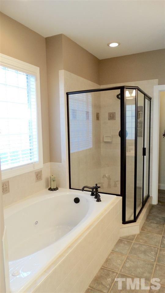 10335 Evergreen Spring Place Raleigh, NC 27614 - Photo 12 of 25 Whirlpool Tub, Separate Custom-Tiled Shower with Special Order Shower Enclosure/Door. This can be your Private Retreat.