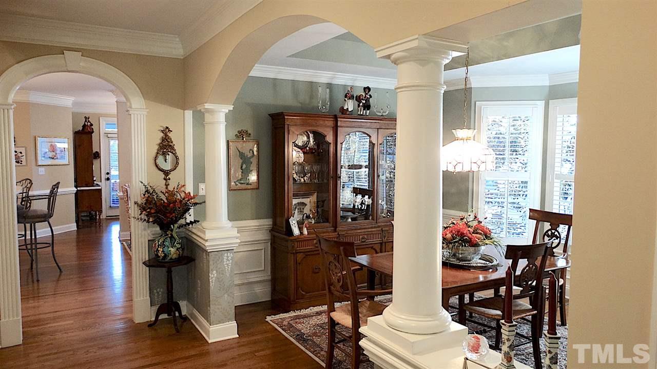 10335 Evergreen Spring Place Raleigh, NC 27614 - Photo 3 of 25 Gorgeous Dining Room with arches, columns, hardwood floors, bow window, wainscoting, tray ceiling, crown moldings!