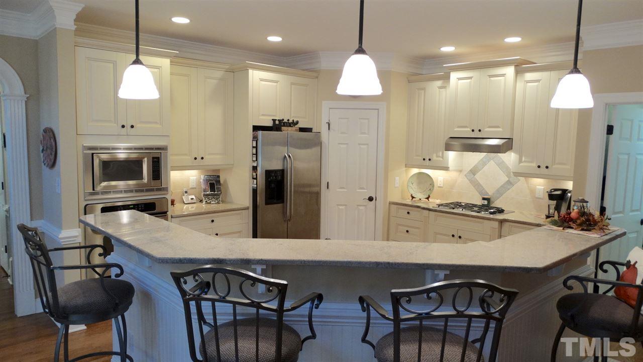 10335 Evergreen Spring Place Raleigh, NC 27614 - Photo 24 of 25 Eating bar, large enough to seat several, Open to Family Room and Breakfast Room - OPEN FLOORPLAN