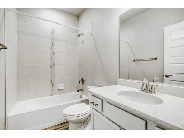 a bathroom with a sink a toilet and a large mirror