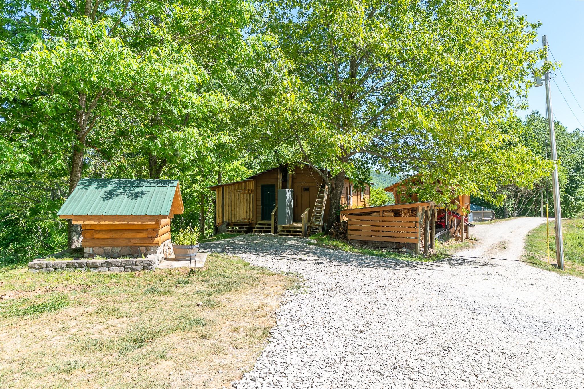 451 Rustic Ridge Drive Canton, NC 28716 - Photo 38 of 44 a backyard of a house with barbeque oven fire pit table and chairs