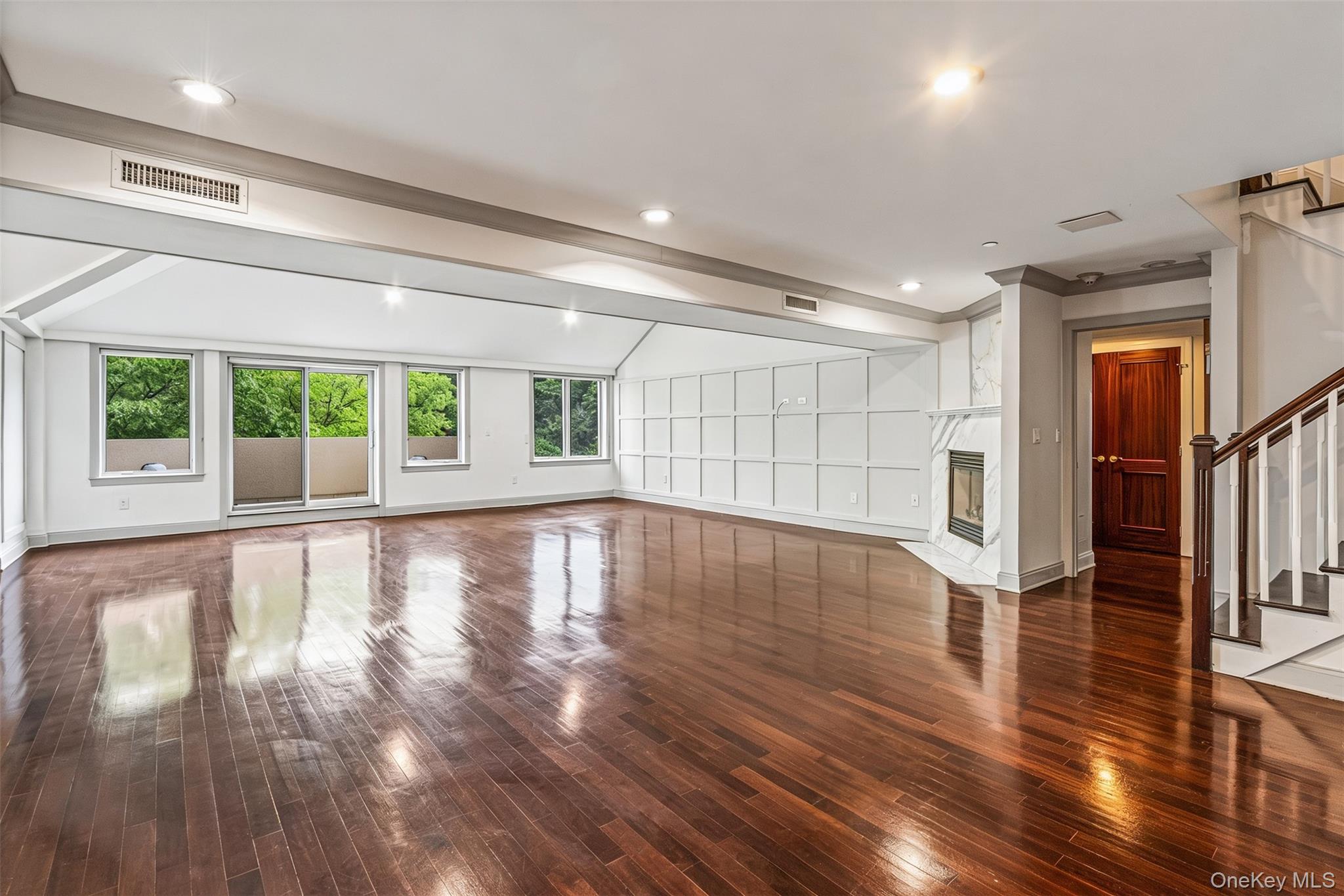 171 Great Neck Road, Unit 4R Great Neck, NY 11021 - Photo 4 of 27 a view of an empty room with wooden floor and a window