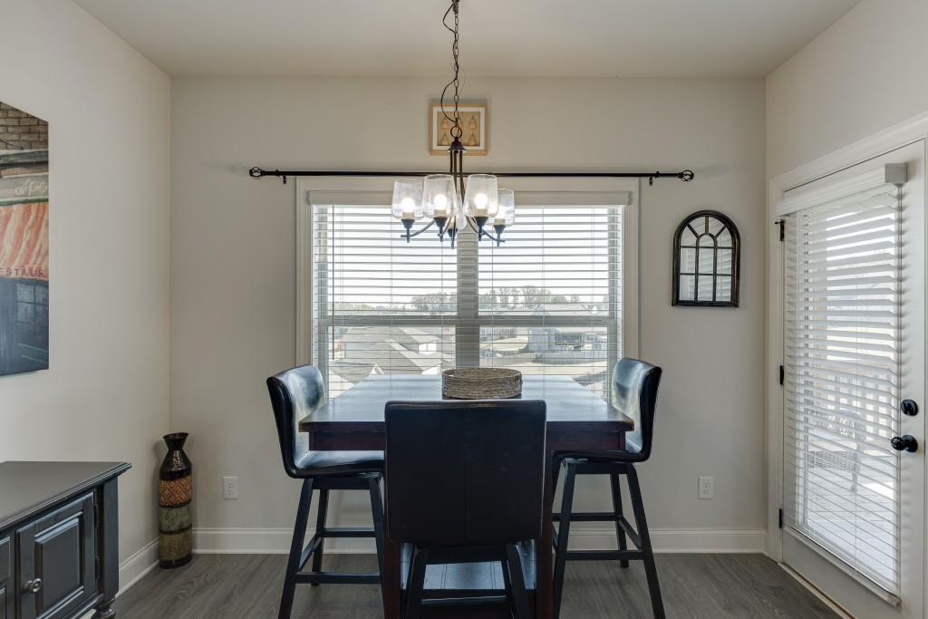 558 Calgary Downs Drive Winder, GA 30680 - Photo 15 of 50 a view of a dining room with furniture window and outside view