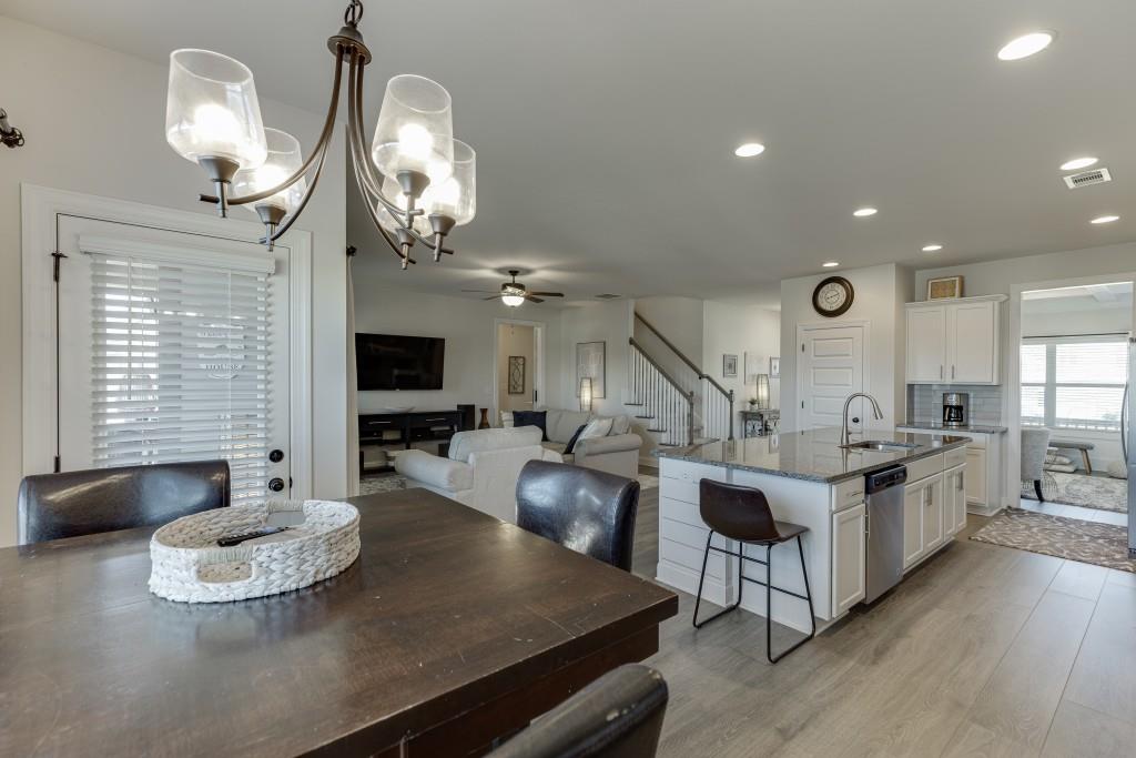 558 Calgary Downs Drive Winder, GA 30680 - Photo 16 of 50 a living room with stainless steel appliances kitchen island granite countertop furniture a fireplace and a large window