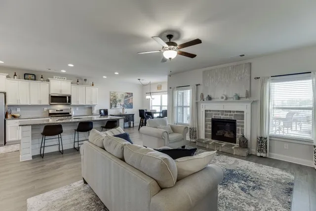 a living room with furniture fireplace and window