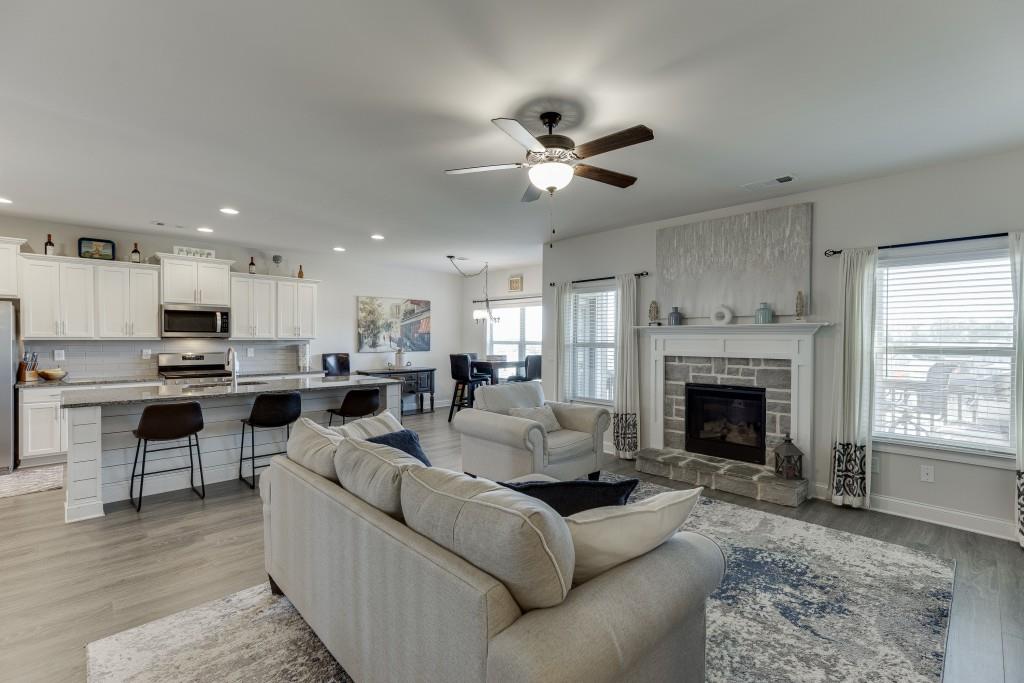 558 Calgary Downs Drive Winder, GA 30680 - Photo 19 of 50 a living room with furniture fireplace and window