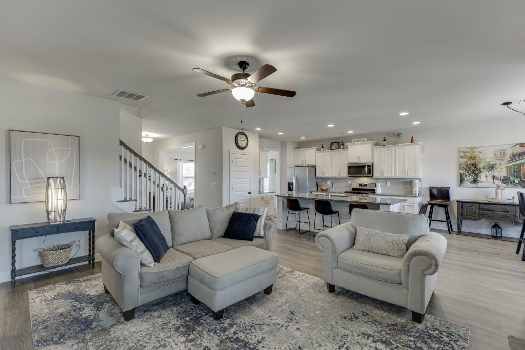 558 Calgary Downs Drive Winder, GA 30680 - Photo 20 of 50 a living room with furniture kitchen view and a chandelier