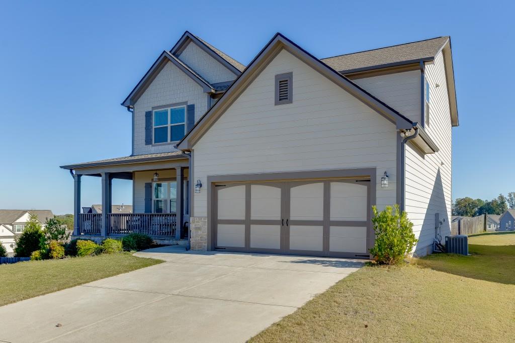 558 Calgary Downs Drive Winder, GA 30680 - Photo 2 of 50 a view of a house with a yard and potted plants