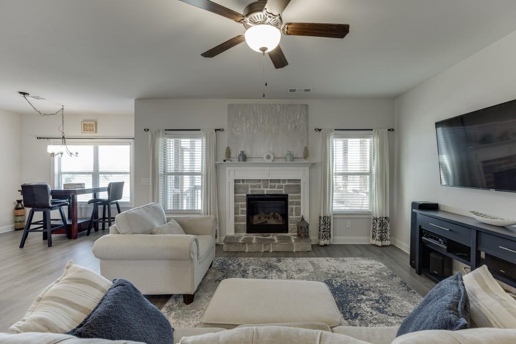 558 Calgary Downs Drive Winder, GA 30680 - Photo 21 of 50 a living room with furniture and a fireplace