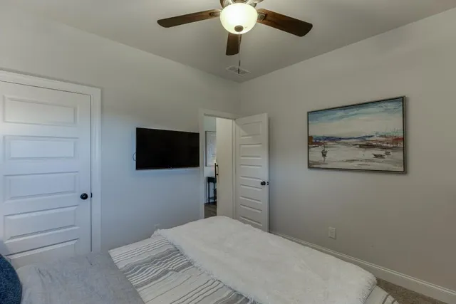 a bedroom with a bed and a flat screen tv