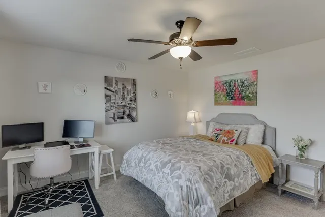 a bedroom with a bed and a chair