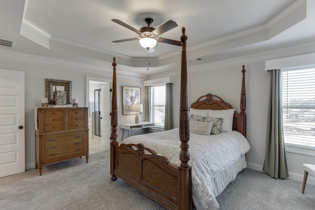 558 Calgary Downs Drive Winder, GA 30680 - Photo 30 of 50 a bedroom with a bed and ceiling fan