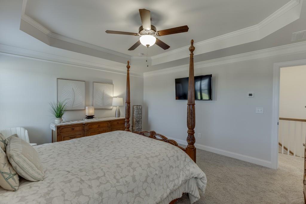 558 Calgary Downs Drive Winder, GA 30680 - Photo 32 of 50 a bedroom with a bed and a chandelier