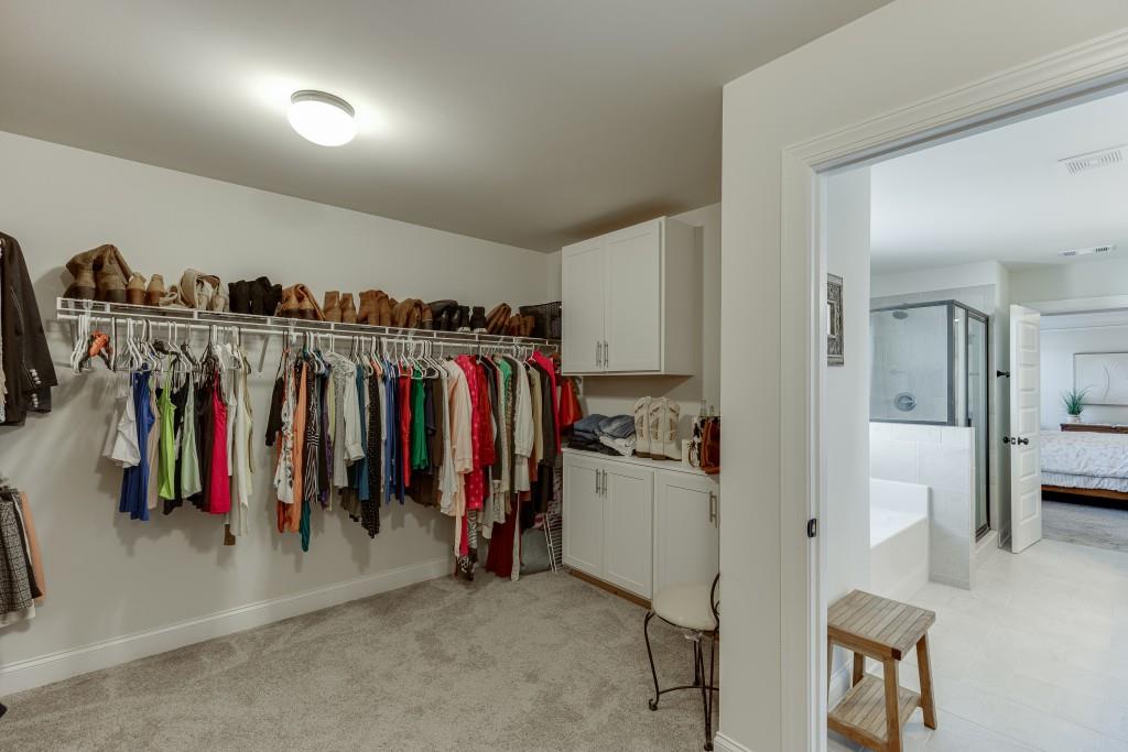 558 Calgary Downs Drive Winder, GA 30680 - Photo 34 of 50 a view of walk in closet with clothes