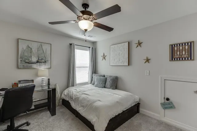a bedroom with a large bed and a chandelier