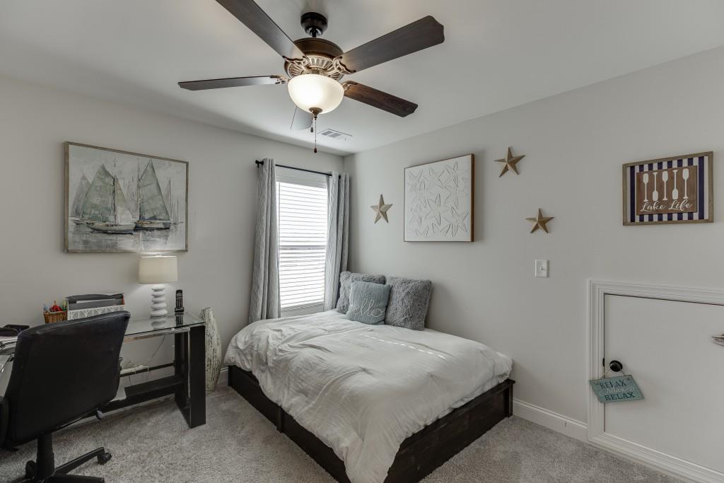 558 Calgary Downs Drive Winder, GA 30680 - Photo 38 of 50 a bedroom with a large bed and a chandelier