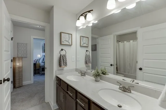 a bathroom with a double vanity sink and a mirror