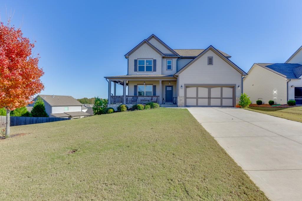 558 Calgary Downs Drive Winder, GA 30680 - Photo 4 of 50 front view of a house with a yard
