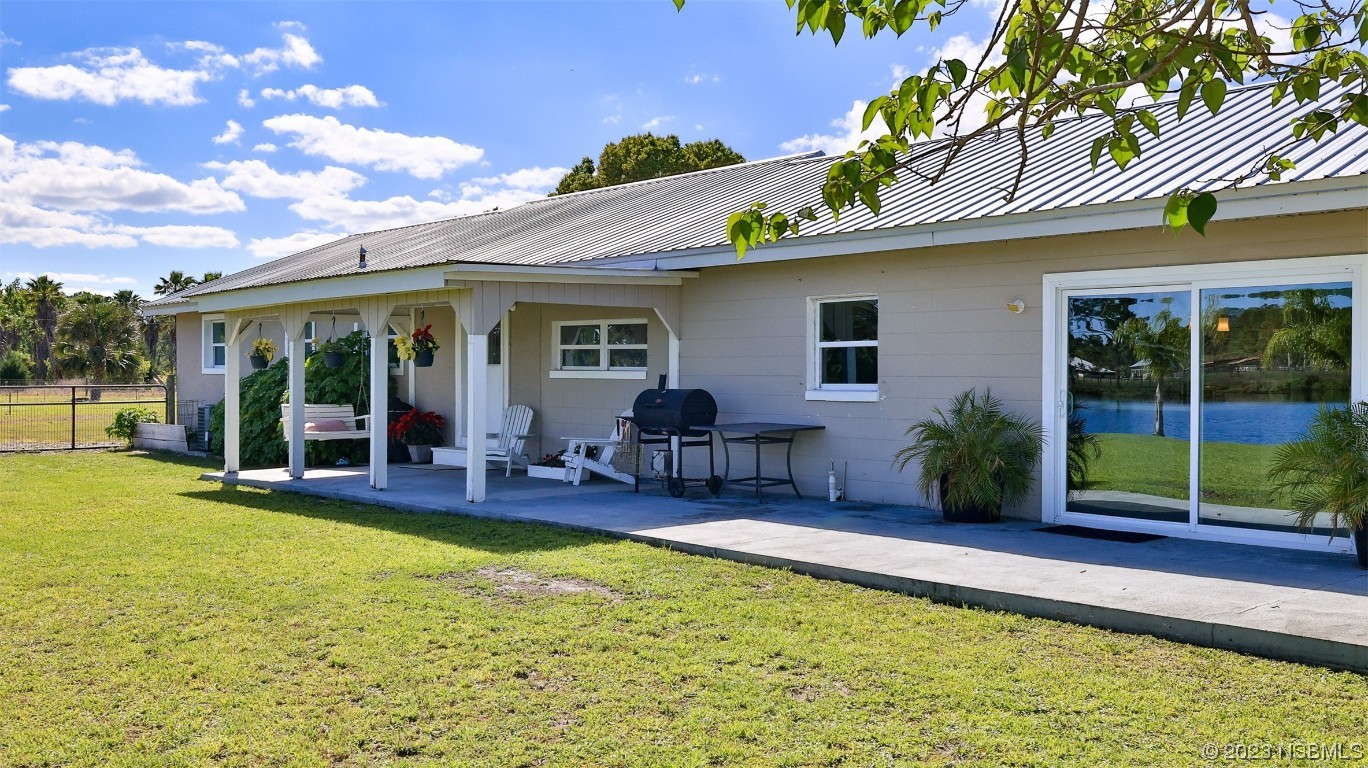 677 State Rte 415 New Smyrna Beach, FL 32168 - Photo 11 of 74 a view of a house with swimming pool and porch with furniture