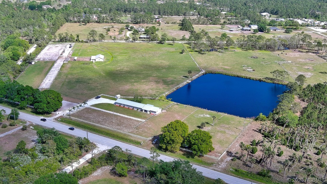 677 State Rte 415 New Smyrna Beach, FL 32168 - Photo 14 of 74 an aerial view of residential houses with outdoor space