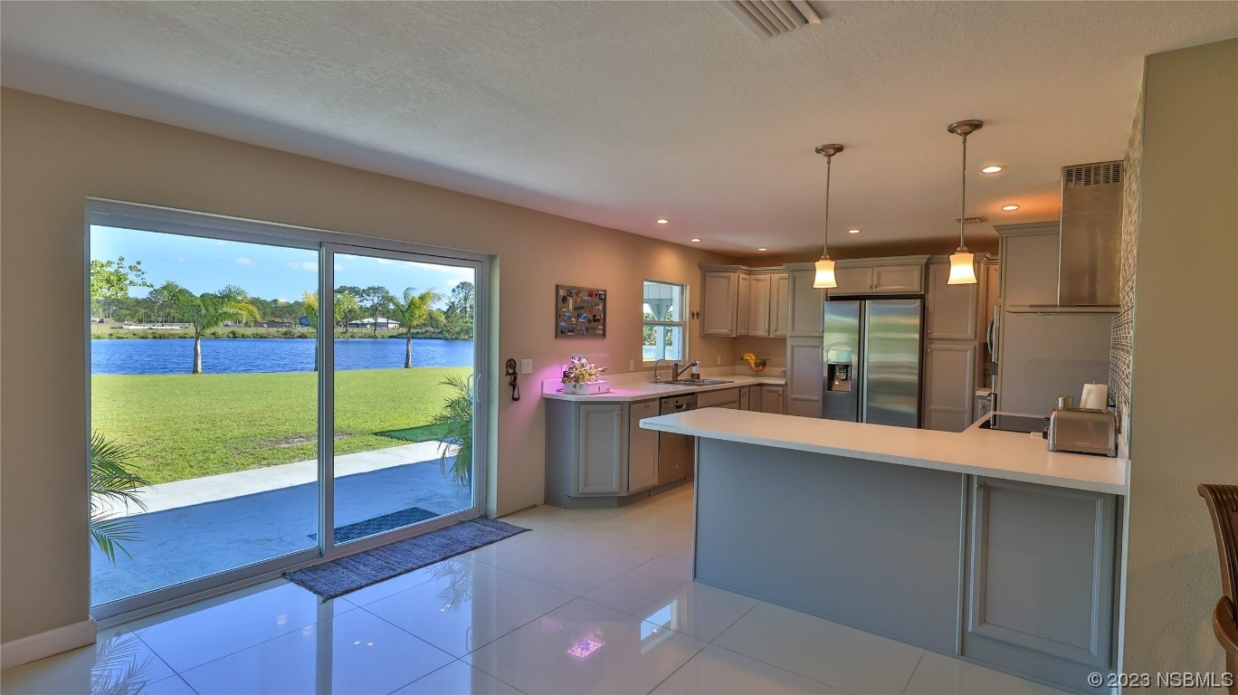 677 State Rte 415 New Smyrna Beach, FL 32168 - Photo 28 of 74 a kitchen with a sink and large cabinets