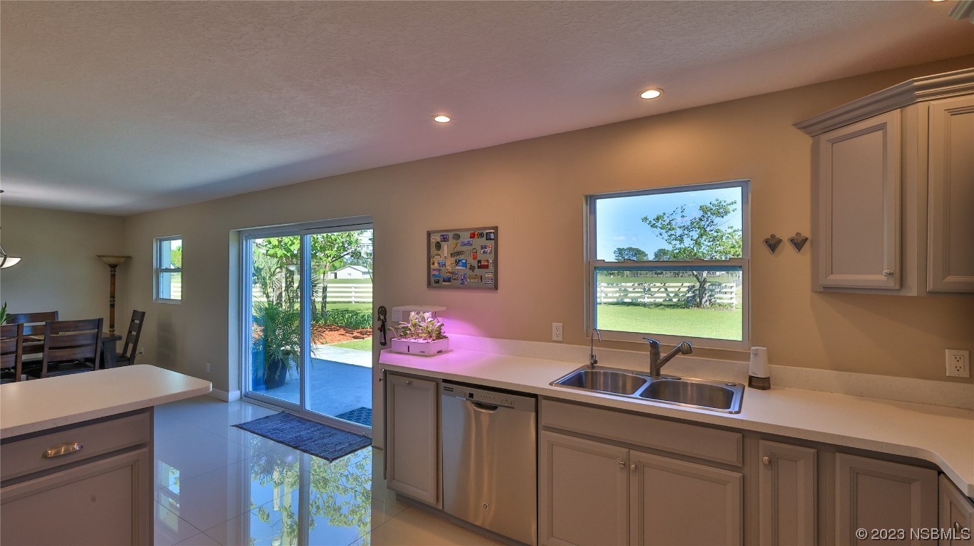 677 State Rte 415 New Smyrna Beach, FL 32168 - Photo 29 of 74 a kitchen with a sink cabinets and wooden floor
