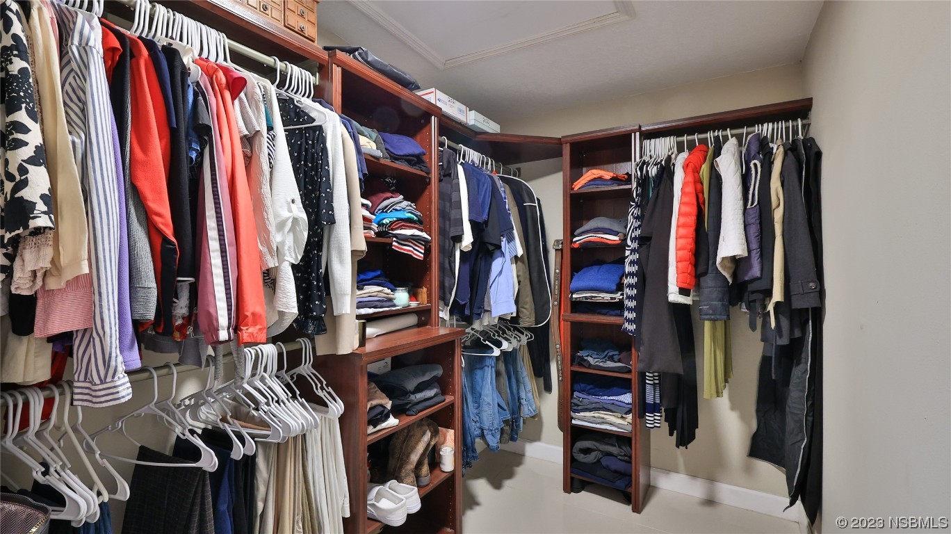677 State Rte 415 New Smyrna Beach, FL 32168 - Photo 39 of 74 a view of walk in closet with clothes