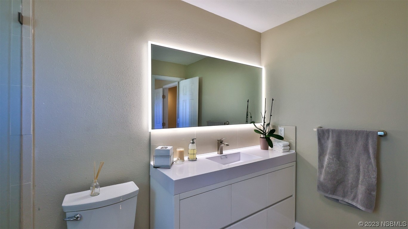 677 State Rte 415 New Smyrna Beach, FL 32168 - Photo 44 of 74 a bathroom with a sink and a toilet