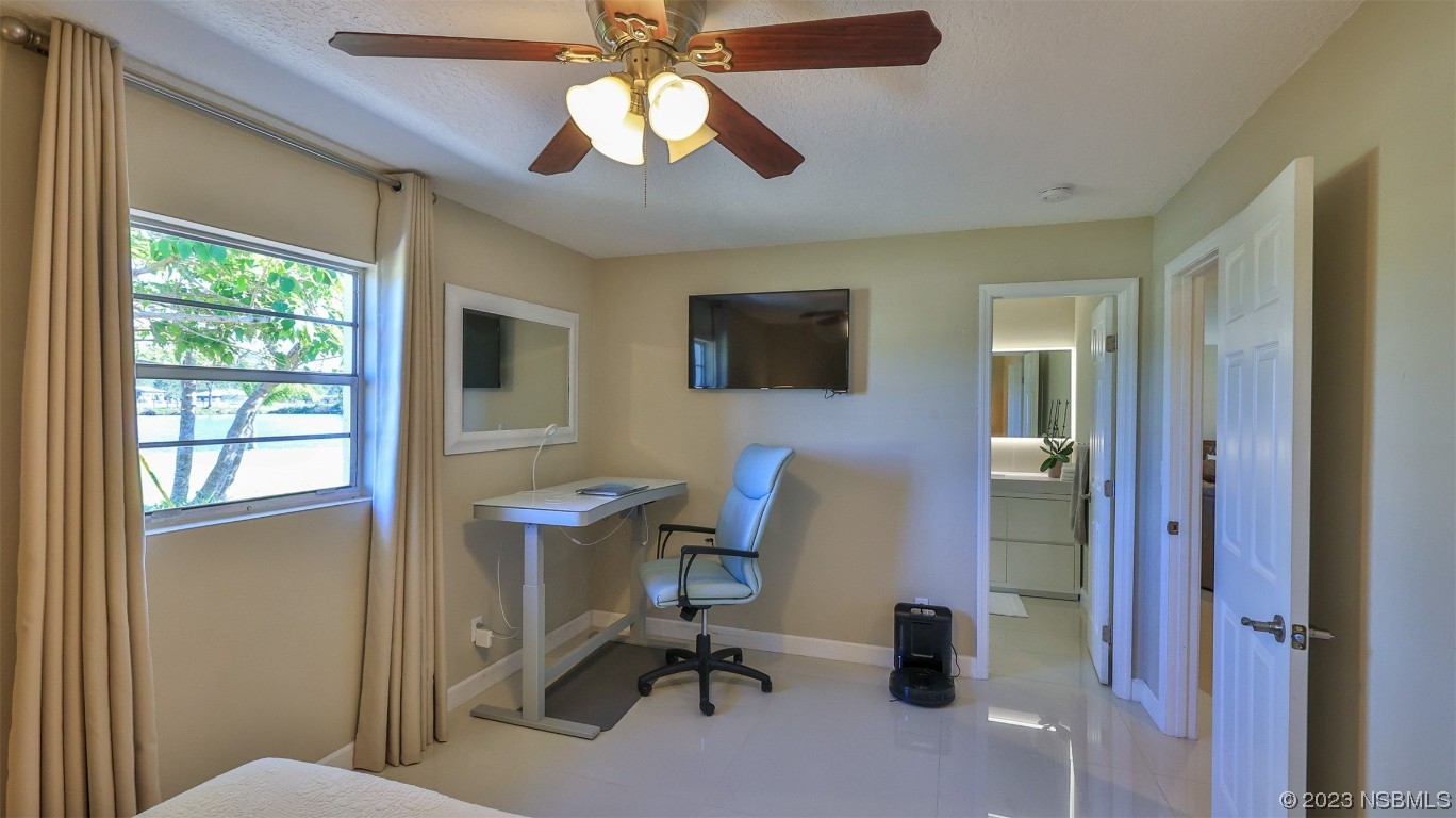 677 State Rte 415 New Smyrna Beach, FL 32168 - Photo 47 of 74 a view of a workspace with furniture and a window