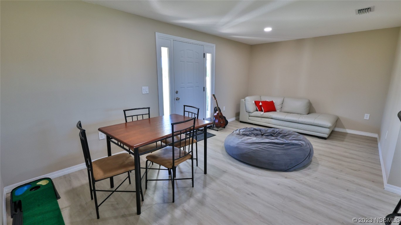 677 State Rte 415 New Smyrna Beach, FL 32168 - Photo 48 of 74 a living room with furniture and wooden floor