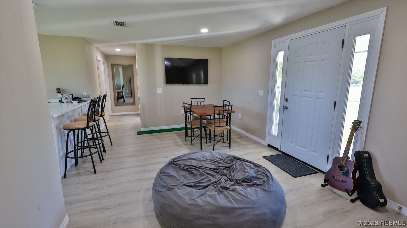 677 State Rte 415 New Smyrna Beach, FL 32168 - Photo 49 of 74 a living room with furniture and a flat screen tv