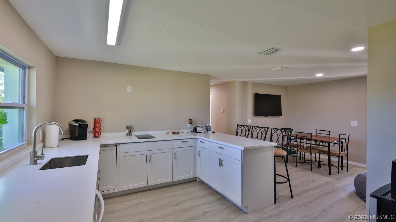 677 State Rte 415 New Smyrna Beach, FL 32168 - Photo 50 of 74 a room with furniture a flat screen tv and a window