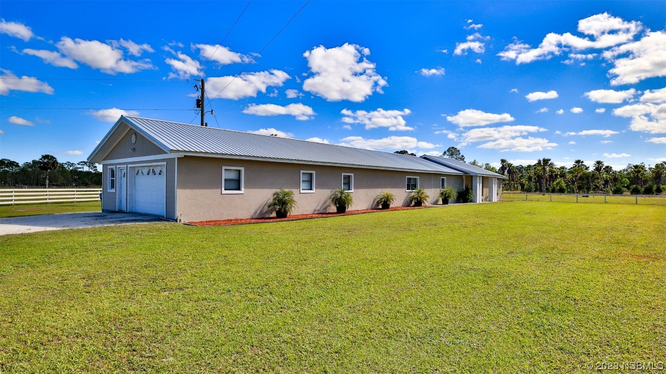 677 State Rte 415 New Smyrna Beach, FL 32168 - Photo 5 of 74 a front view of house with an outdoor space and swimming pool