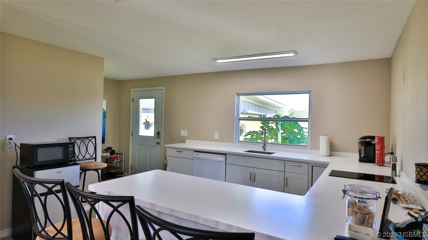 677 State Rte 415 New Smyrna Beach, FL 32168 - Photo 52 of 74 a kitchen with a table and chairs in it