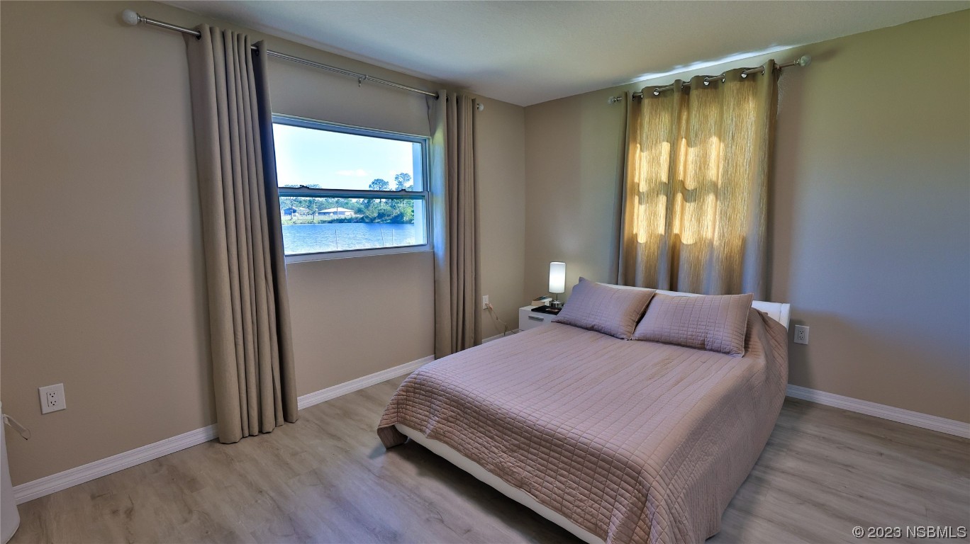 677 State Rte 415 New Smyrna Beach, FL 32168 - Photo 54 of 74 a bedroom with a bed and a window