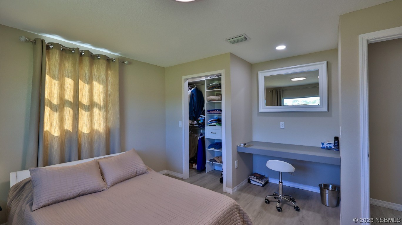 677 State Rte 415 New Smyrna Beach, FL 32168 - Photo 56 of 74 a bedroom with a bed and a chair