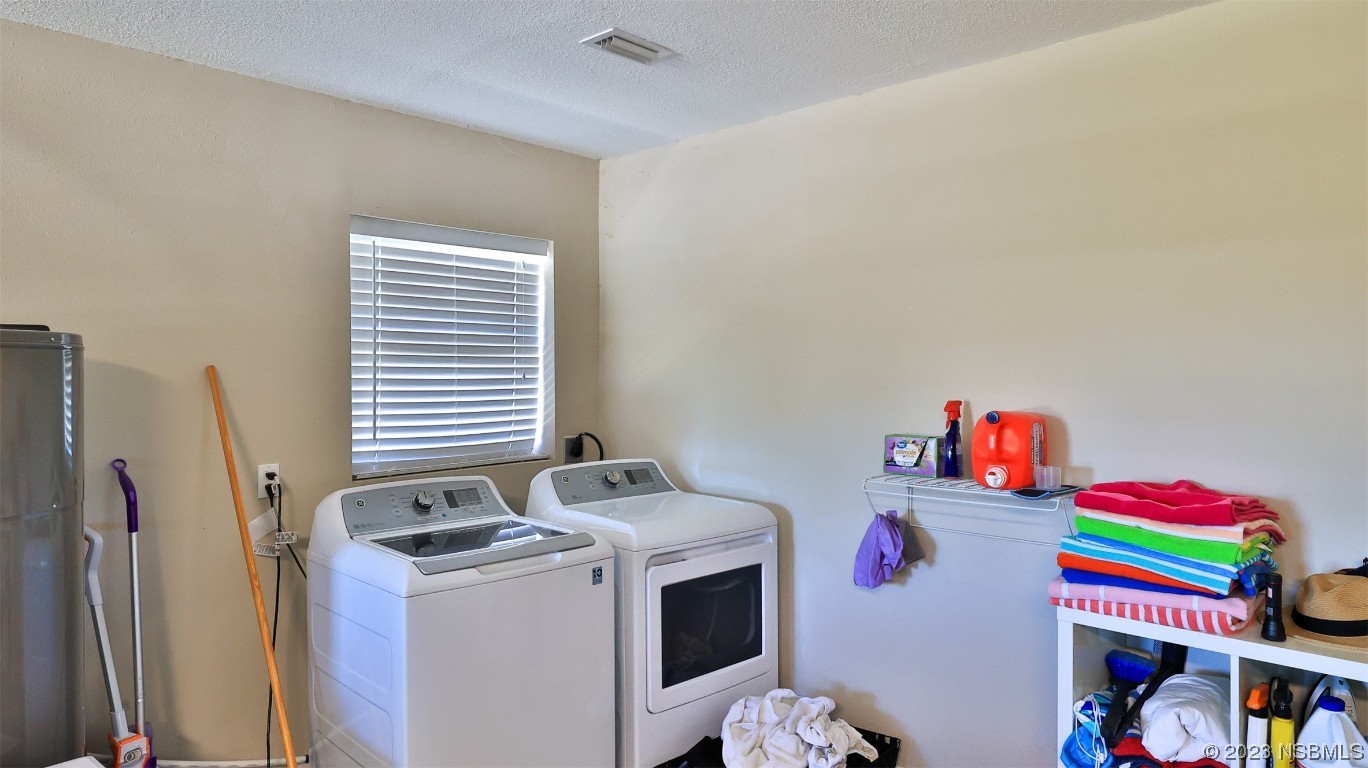 677 State Rte 415 New Smyrna Beach, FL 32168 - Photo 57 of 74 a utility room with dryer and washer