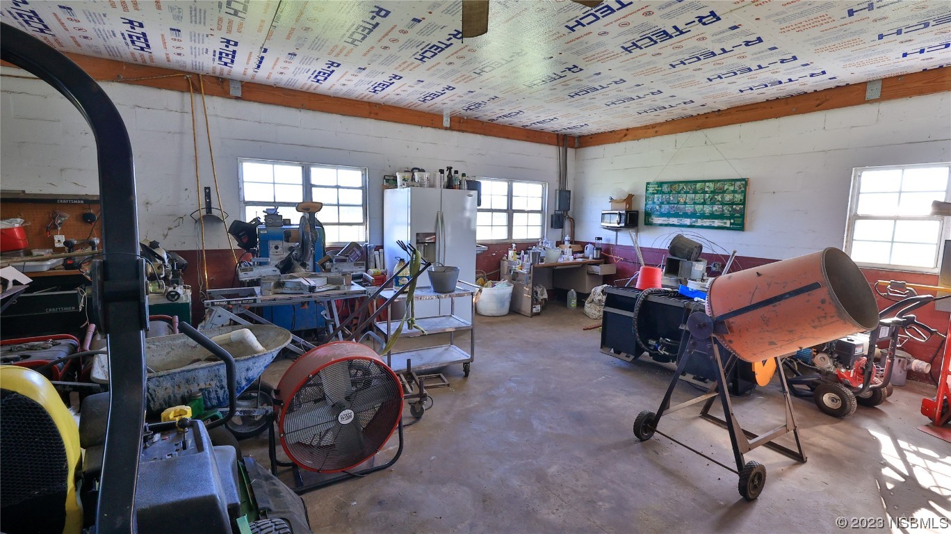 677 State Rte 415 New Smyrna Beach, FL 32168 - Photo 62 of 74 a living room with furniture a window and gym equipment