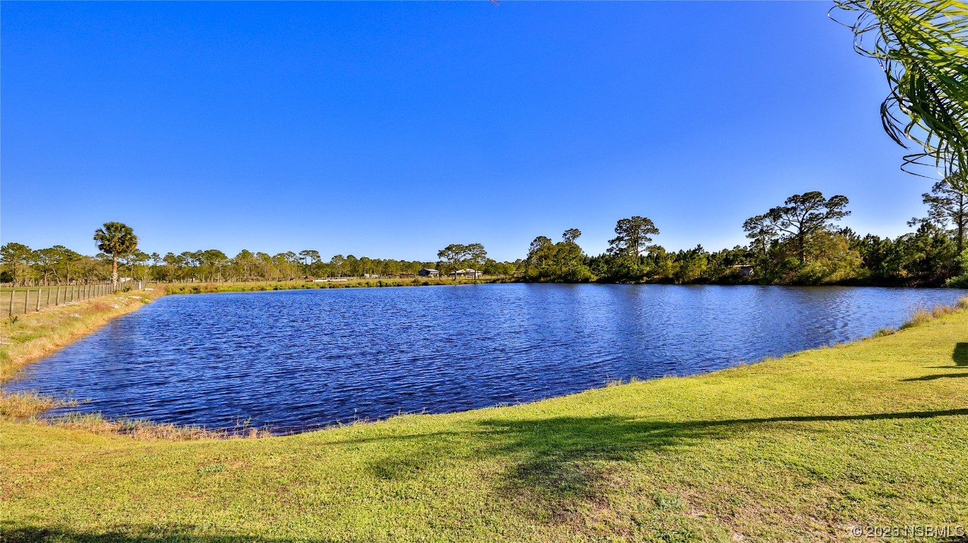 677 State Rte 415 New Smyrna Beach, FL 32168 - Photo 64 of 74 a view of a lake with houses in the back