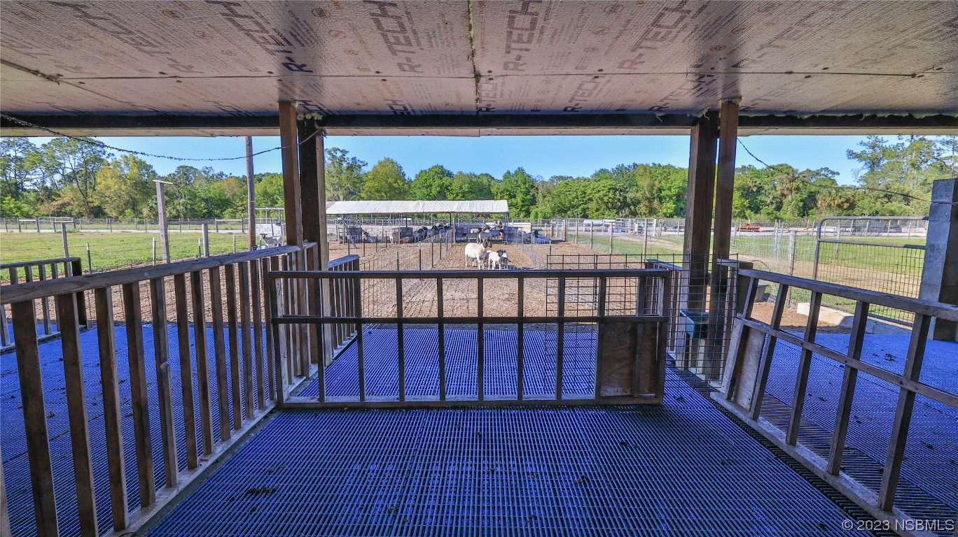 677 State Rte 415 New Smyrna Beach, FL 32168 - Photo 66 of 74 a view of a porch with wooden floor in outdoor space