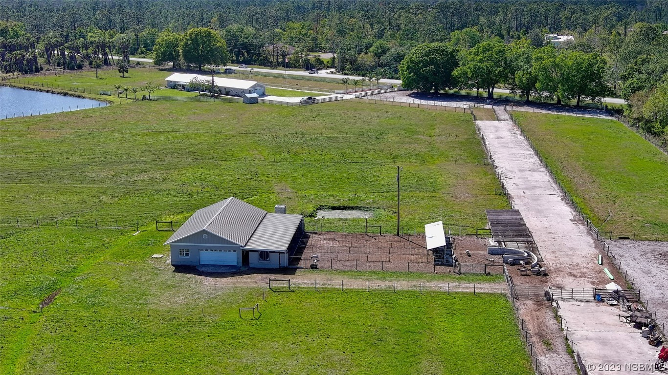 677 State Rte 415 New Smyrna Beach, FL 32168 - Photo 73 of 74 a view of a swimming pool with a garden
